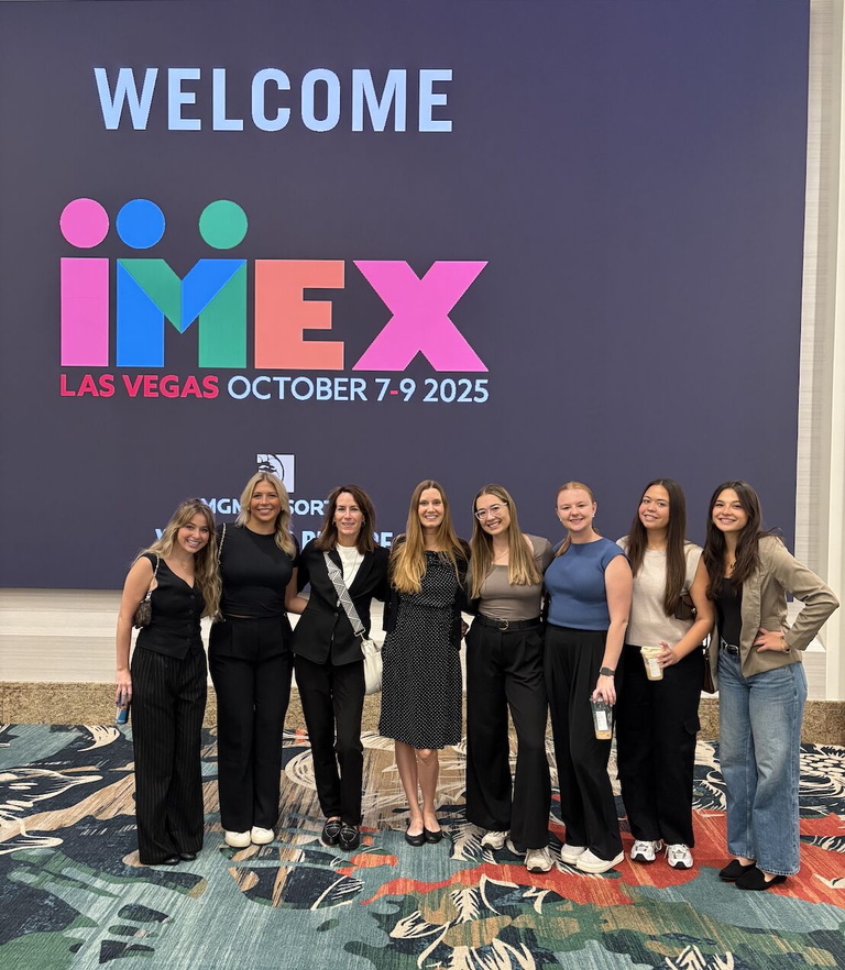 Six event mgmt seniors posing for a picture with Tracy and Heather