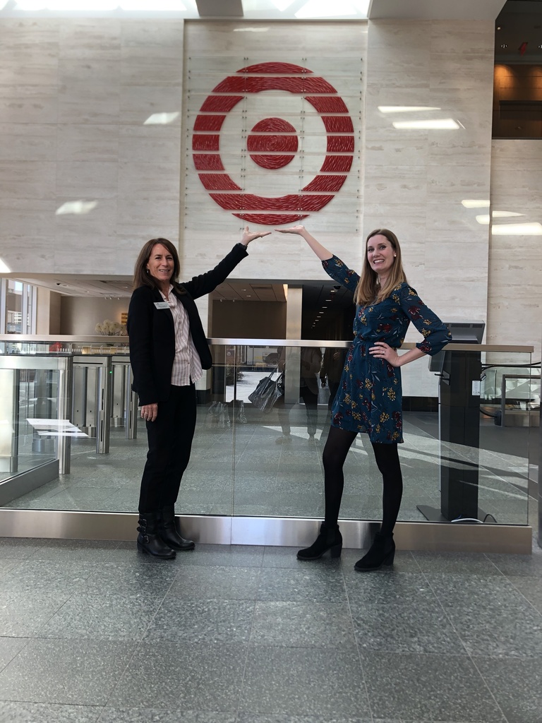 Heather and Tracy posing for a photo with their arms up at Target