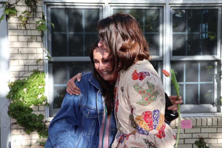 Sammy Meents, senior, and Susan Brennan, faculty member, hugging at the Spring Graduation celebration