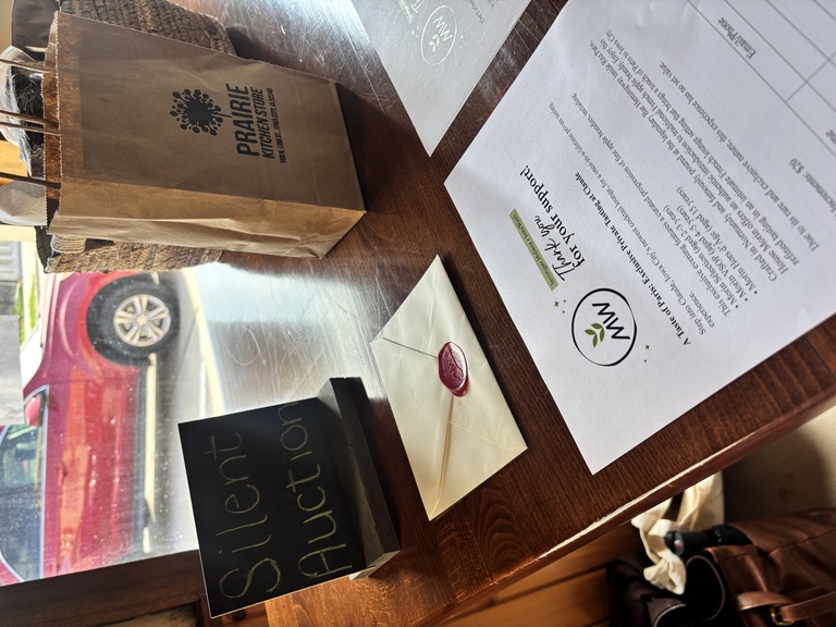 silent auction photo with a letter, bag, and sheet 