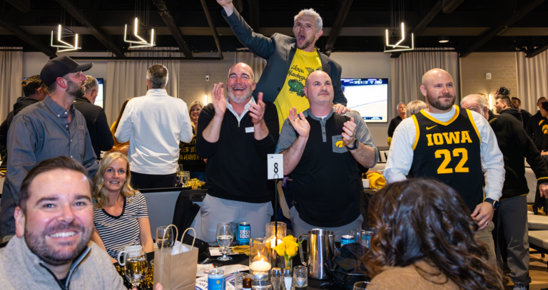 Men cheering while watching basketball game
