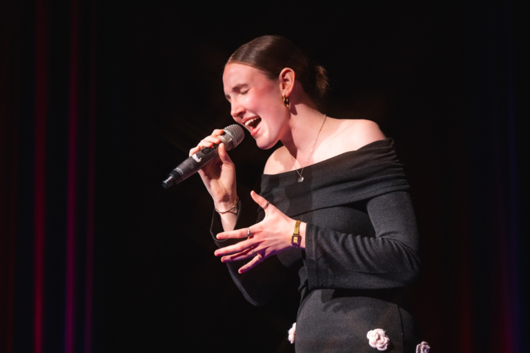 Woman singing in a black outfit